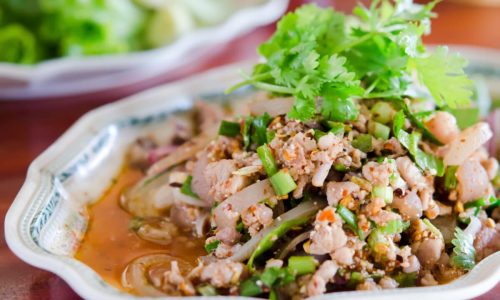 Thai style cuisine , spicy minced pork  with mix vegetable on dish